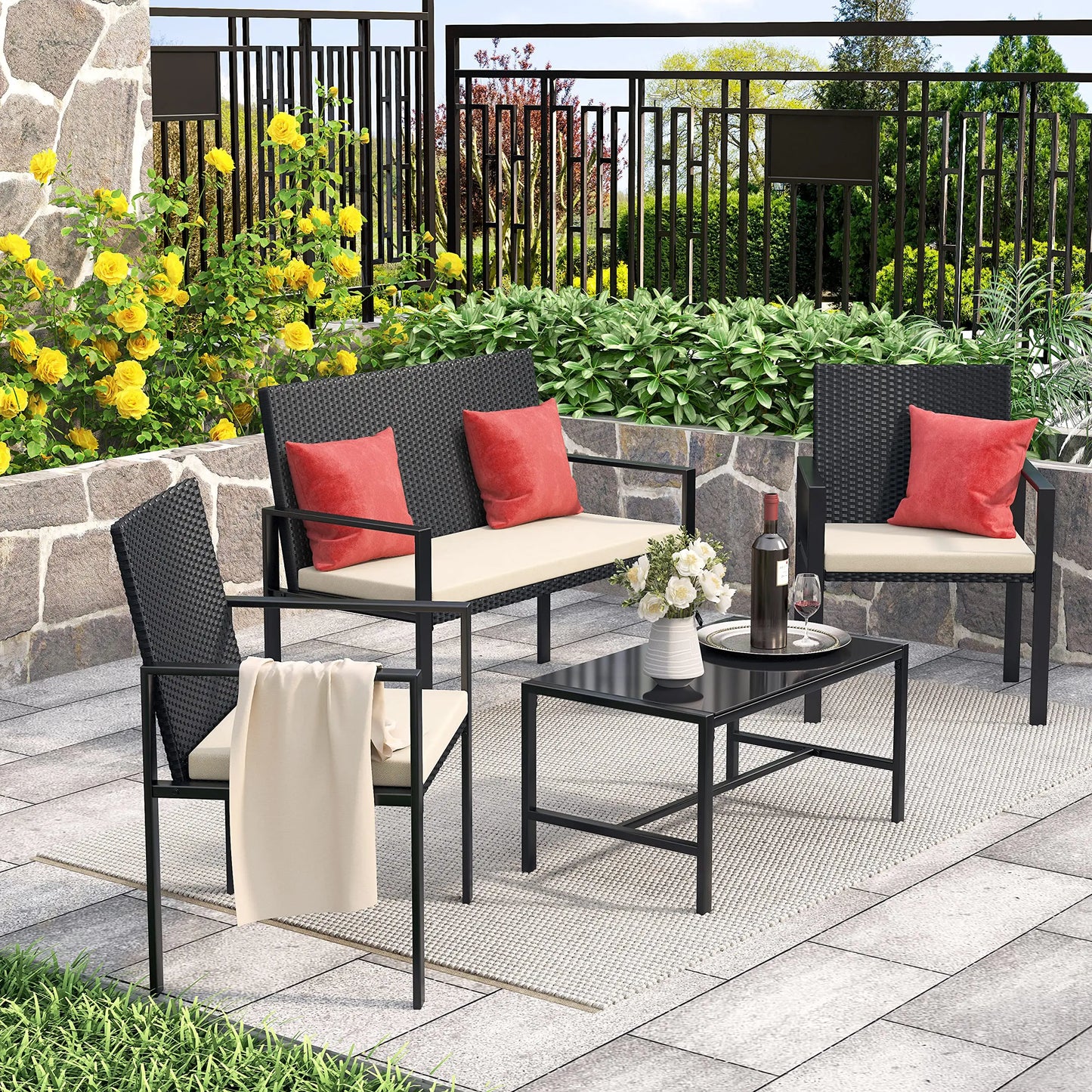 Norrvyn Arto | 4-teiliges Garten-Lounge-Set aus schwarzem Polyrattan mit Glastisch